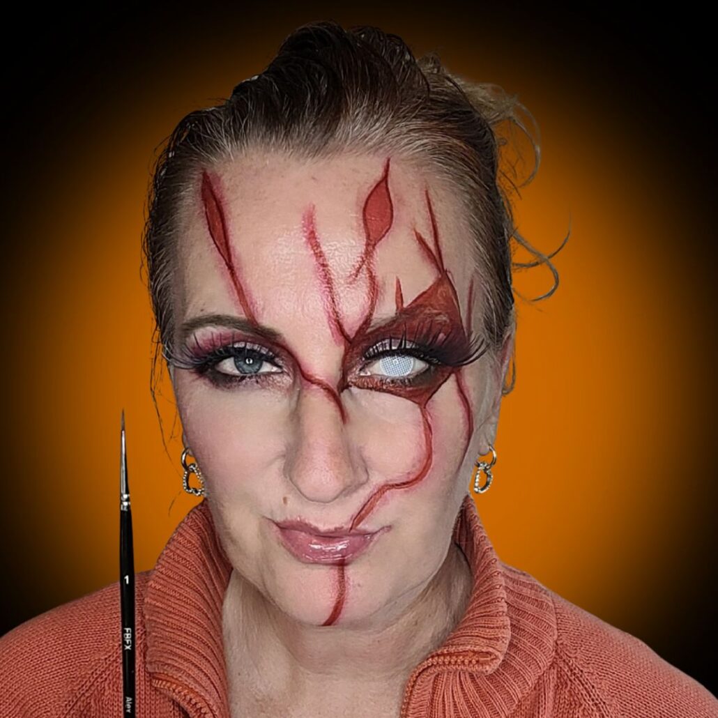 Chucky Halloween make-up met rode en zilveren strass steentjes, glam horror look, verkrijgbaar bij SchminkenGrime.nl